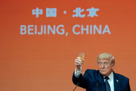 a man in a suit raises a glass