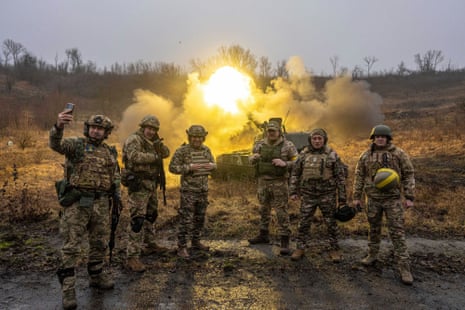 Ukrainian servicemen pose for a photo during the shoot towards Russian forces of self-propelled artillery at a frontline in Kharkiv region, Ukraine.