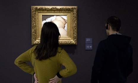 Visitors view Gustave Courbet’s painting at the Musée d’Orsay.