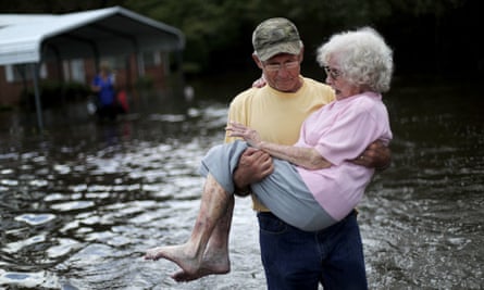 Bob Richling carries Iris Darden, 84, out of her flooded home as her daughter-in-law, Pam Darden, gathers her belongings in the aftermath of Hurricane Florence in Spring Lake, North Carolina, Monday.