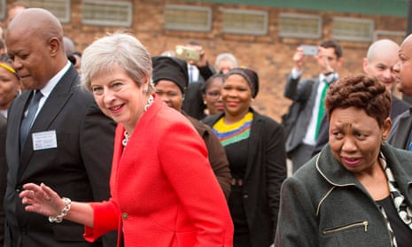 Theresa May dances with pupils at a South African school on Tuesday