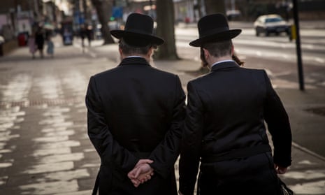 Jewish men walk in Stamford Hill, London.