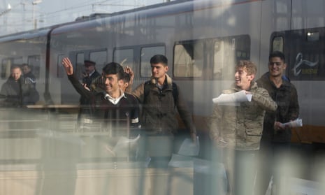 A Syrian and five Afghan boys on the platform of Calais train station, northern France, on their journey to Britain