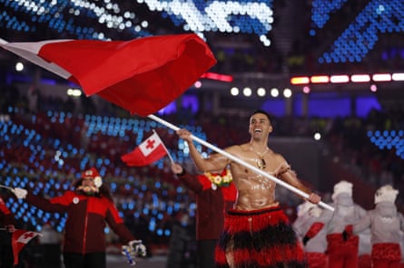 Pita Taufatofua carries the Tongan flag during the 2018 Winter Olympics opening ceremony in Pyeongchang, South Korea.