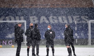 The managers and match officials in discussion.