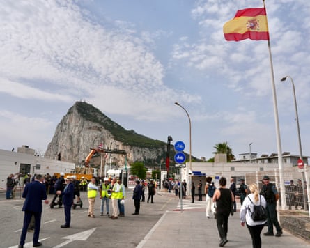 People walk across the border between Spain and Gibraltar in La Línea de la Concepción on Wednesday as the iron border gates are removed.