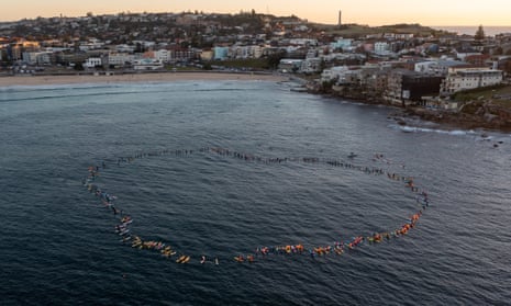 Members of the paddle-out form a giant heart.