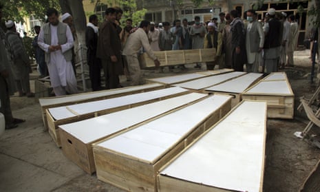 The coffins of the victims of Tuesday’s attack are placed on the ground at a hospital in northern Baghlan province, Afghanistan
