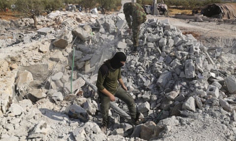 Two men stand on the rubble of destroyed houses near the village of Barisha in Syria’s Idlib province, after the operation targeting Abu Bakr al-Baghdadi.