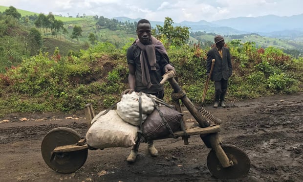 Travellers on muddy road in DRC.