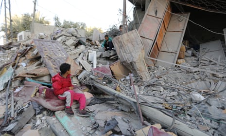Two boys sit amongst the rubble as people inspect damage and recover items from their homes following Israeli air strikes on April 02, 2024 in Rafah, Gaza. Despite warnings from US president Joe Biden, Israeli forces have targeted the city of Rafah which is currently home to an estimated million Palestinian refugees.