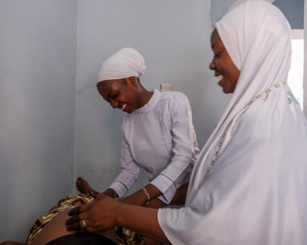 ‘Difficult choices’: aid cuts threaten effort to reduce maternal deaths in Nigeria Nurses examine a pregnant woman