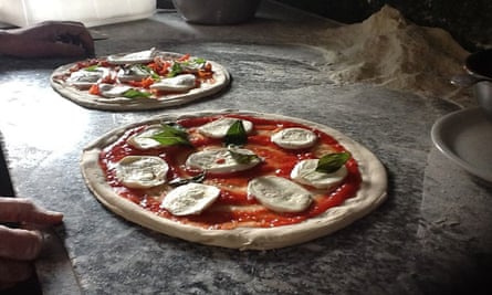 Two freshly prepared pizzas at Fratelli Cafasso, Naples, Italy.