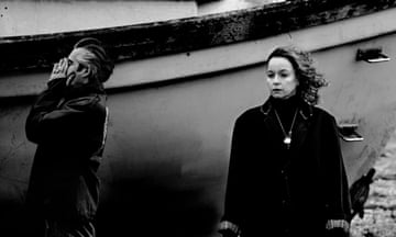 Black and white shot of Samantha Morton and Richard Russell behind them is a boat on a beach.