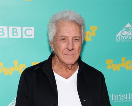 Dustin Hoffman standing against boarding with Twiggy and BBC written on it