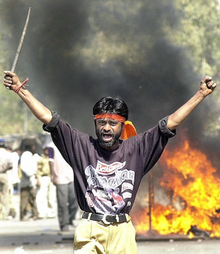 A Bajrang Dal Hindu nationalist brandishes an iron rod in Ahmedabad in 2002..