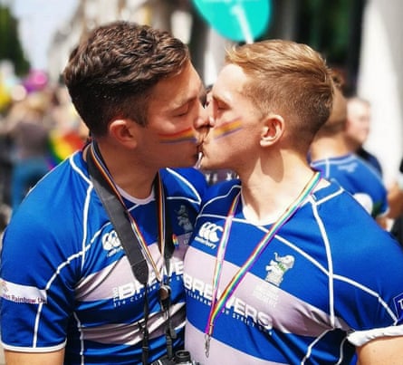 two men in rugby jerseys kissing