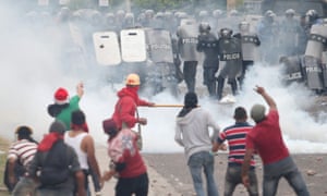 Supporters of presidential candidate Salvador Nasralla clash with police as they wait for official presidential election results in Tegucigalpa.