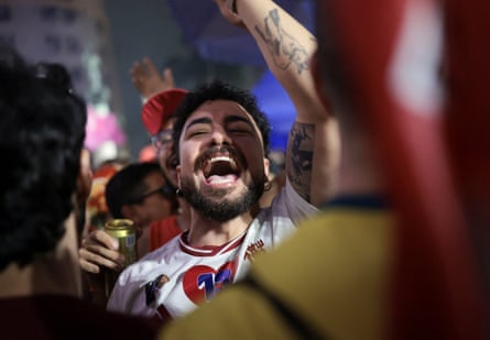 A Lula supporter celebrates after the election result is announced.