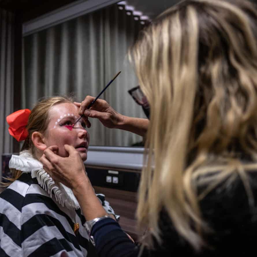 Emilie van den Hooyen, a performer and student at the College of Magic, has her face painted before a performance at the Artscape theatre centre.