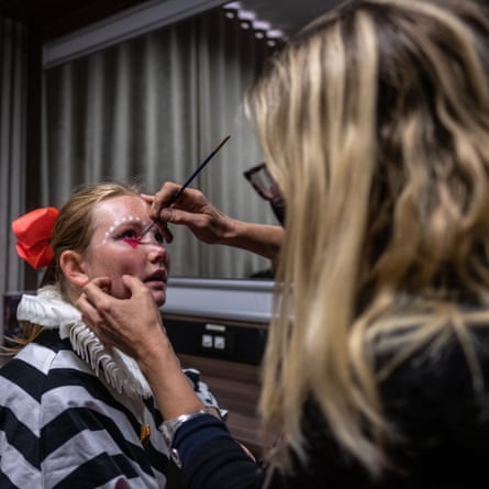 Emilie van den Hooyen, a performer and student at the College of Magic, has her face painted before a performance at the Artscape theatre centre.