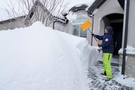 A man shovels snow from the entrance of his house in Draper, Utah, on 23 February 2023.
