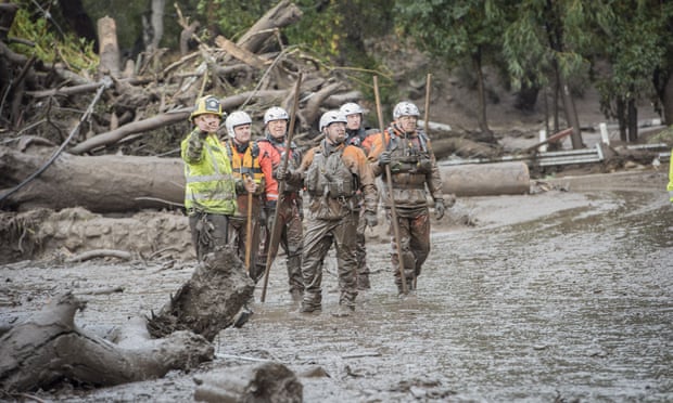 Rescuers working together after the ma s sive mudslide in southern California