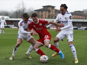 Crawley Town’s Nicholas Tsaroulla, centre, duels for the ball with Leeds United’s Helder Costa, right, and Jamie Shackleton.