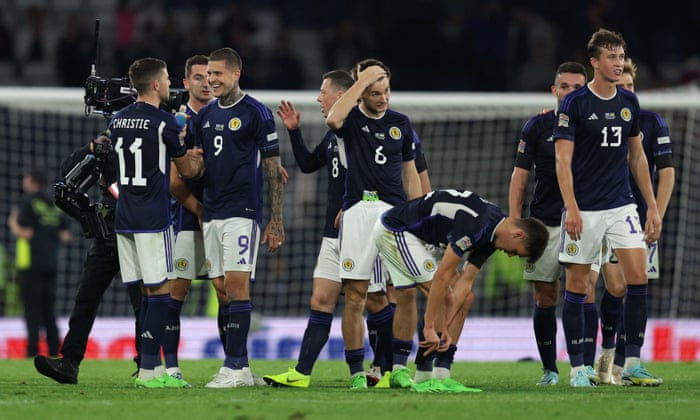 Scotland’s Lyndon Dykes (second left) celebrates with Kieran Tierney and team-mates after the final whistle.