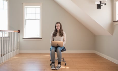 molly white sits for a portrait with her laptop open in a house  in maine usa