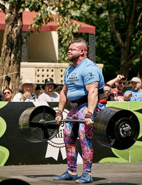 Kearney strains as he lifts a huge set of weights