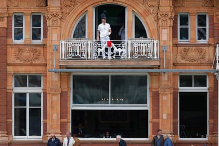 A wide shot of the Lord’s home players’ dressing room shows the England men’s Test captain Ben Stokes, in his whites, looking out from the balcony during a rain break on day 3 of the Test match against New Zealand.