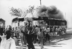 Young men surround a burning bus during the Soweto Uprising in Johannesburg 1976