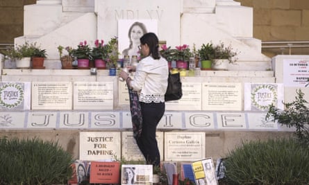 Mandy Mallia lights candles at a memorial to her sister Daphne Caruana Galizia