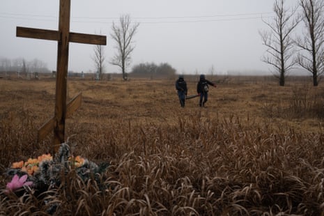 Officers of the Donetsk DSNS demining team work to clear mines and unexploded ordnance from the area outside Lyman.