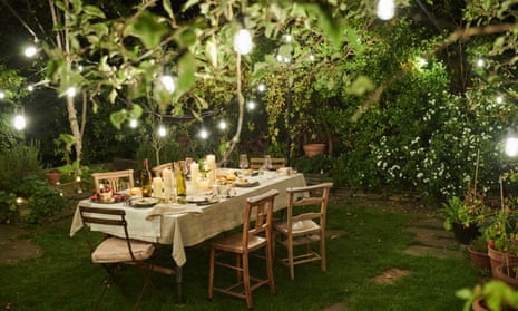 Still life of a dressed dining table set for six people. Dining table outside in a garden. Al fresco dining.