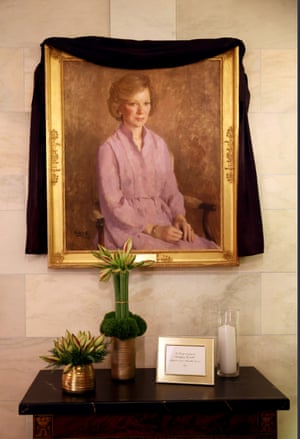 A picture of Carter is curtained in black bunting amongst the vacation decors at the White House in Washington DC
