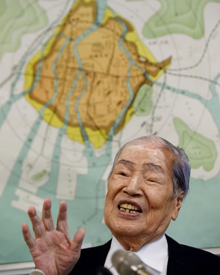 Sunao Tsuboi, 90, in front of a map showing the scale of the damage to Hiroshima