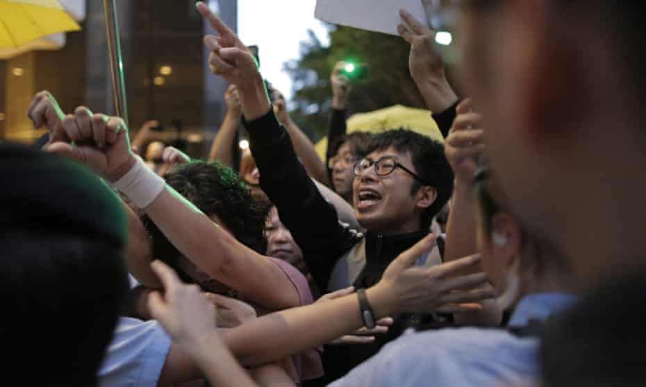 Pro-democracy activists are blocked by policewomen in Hong Kong.