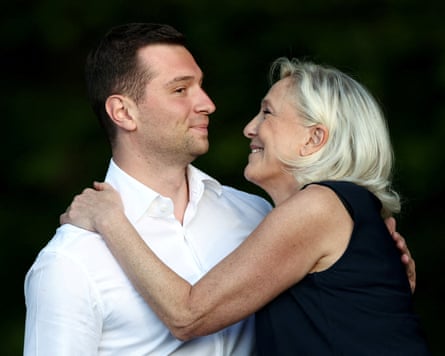 Le Pen smiles at Bardella as they hug