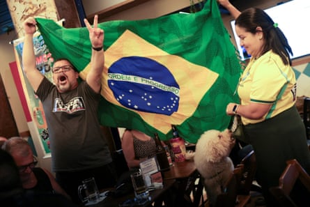 Supporters of Flávio Bolsonaro react after the country's electoral authority announced the runoff.