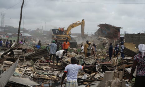 A bulldozer tears through a house in Badia East, an informal settlement in Lagos, Nigeria that has been destroyed without any support for the residents.