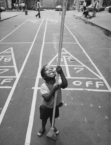 A child holds a shuffleboard stick