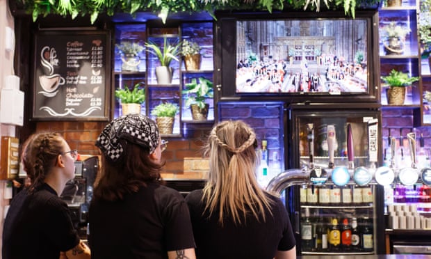 Members of staff watch the Queen's funeral at the Lion pub in Treorchy, Wales.