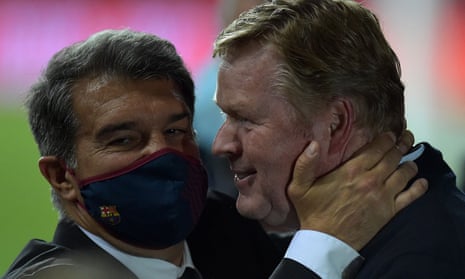 Barcelona’s manager, Ronald Koeman, is embraced by the club’s president, Joan Laporta, after winning the Copa del Rey in April.
