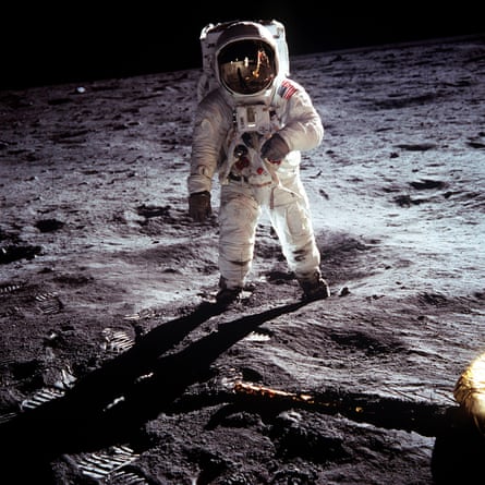 Buzz Aldrin stands on the moon.