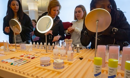 Millennials trying on makeup crowd the Glossier brick-and-mortar store in Soho in New York on Wednesday, March 20, 2019. 