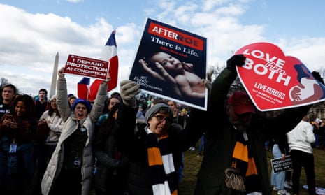 Anti-abortion demonstrators hold signs during the annual March for Life in Washington DC.