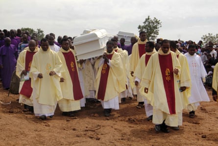 Clergymen carry white coffins containing the bodies of priests allegedly killed by Fulani herdsmen in Gwer East district of Benue State, north-central Nigeria in May 2018.