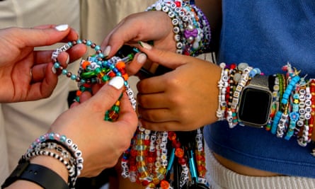 Close-up of fans' hands exchanging bracelets